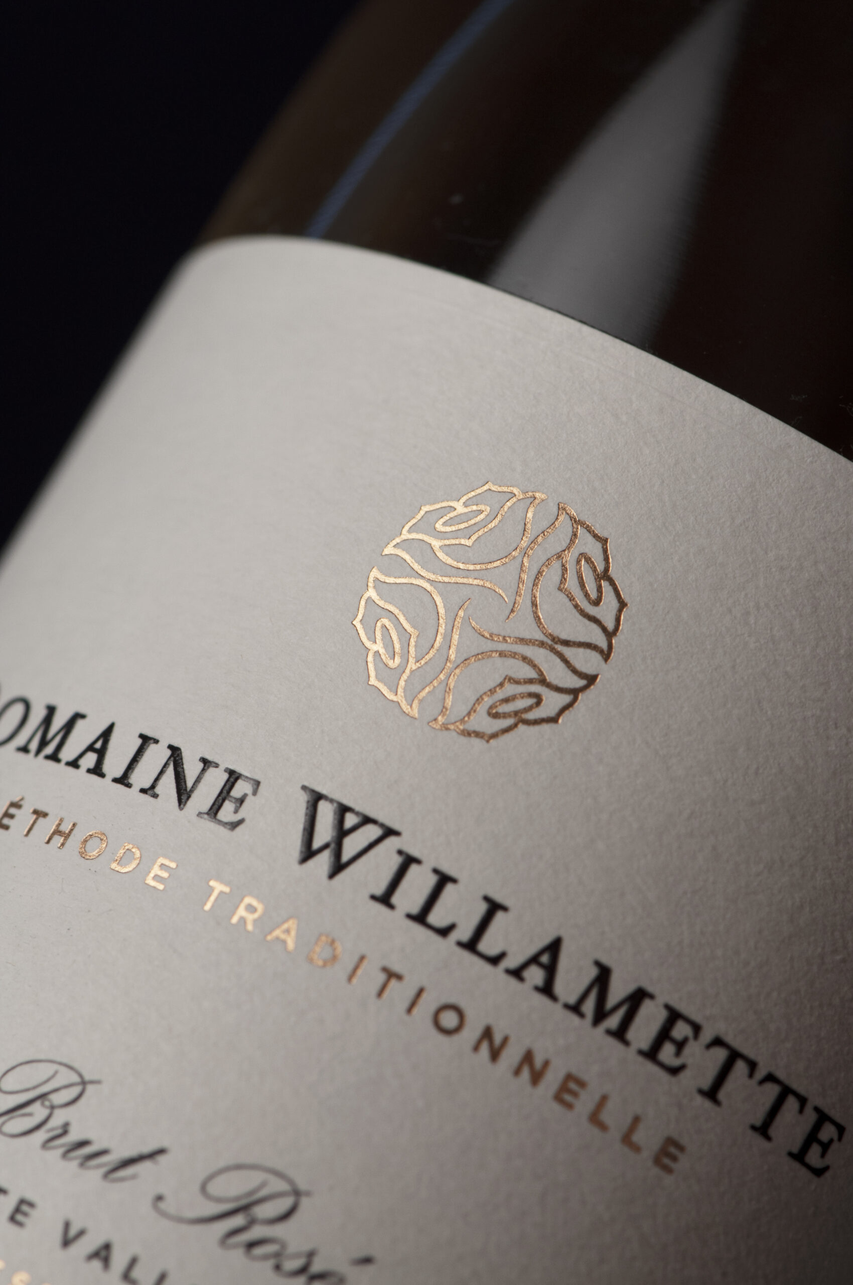 Close-up of a wine bottle label featuring Domaine Willamette and a decorative gold emblem.